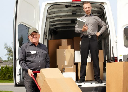 Removal team moving furniture carefully with safety focus