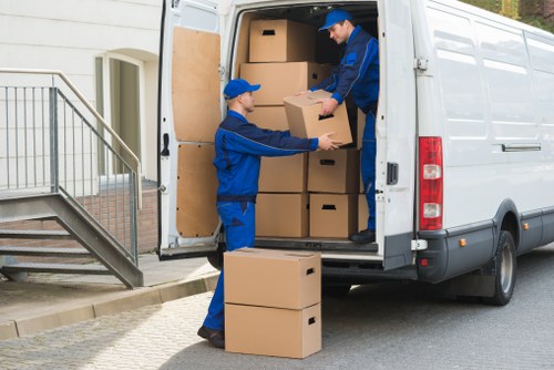 Helper carrying boxes during a Croydon property move