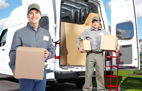 Loading household boxes into a moving van in Croydon